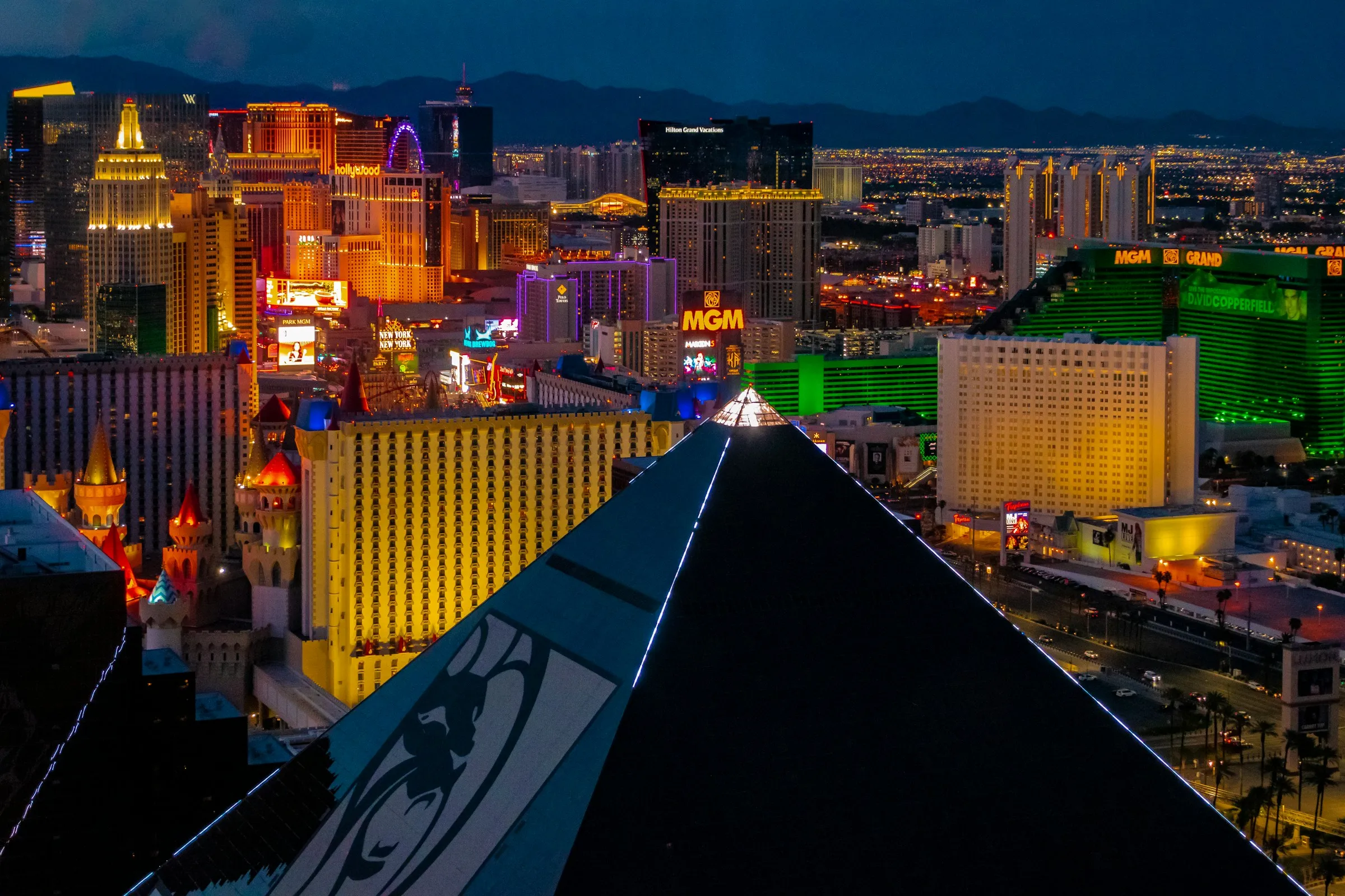 The Las Vegas skyline at night, the Strip lit up beneath the desert sky